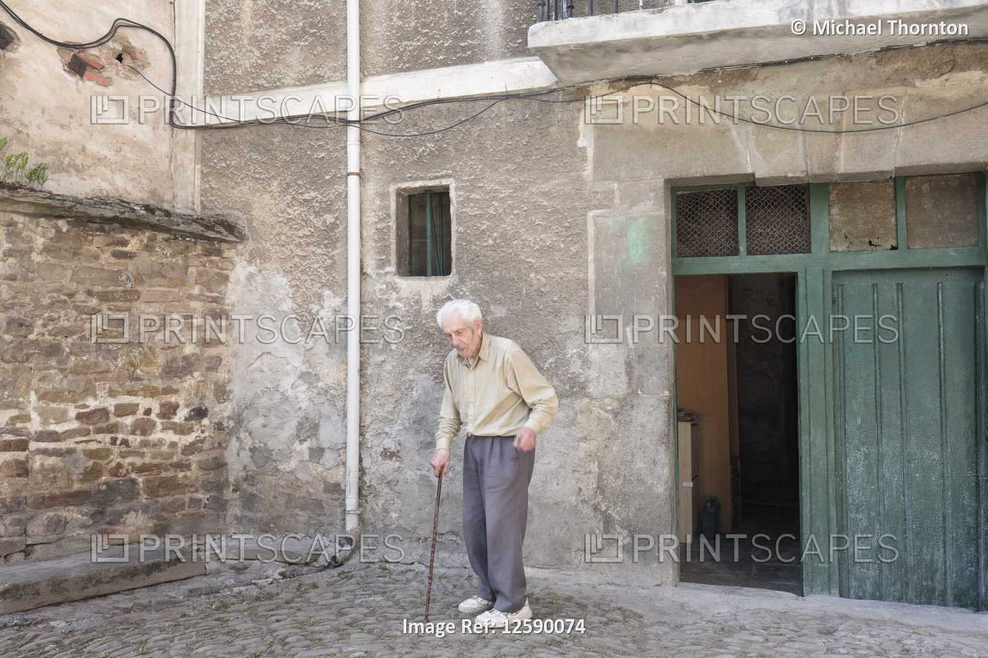 Elderly Spanish gentleman with walking stick, outside his home in Balmaseda, ...