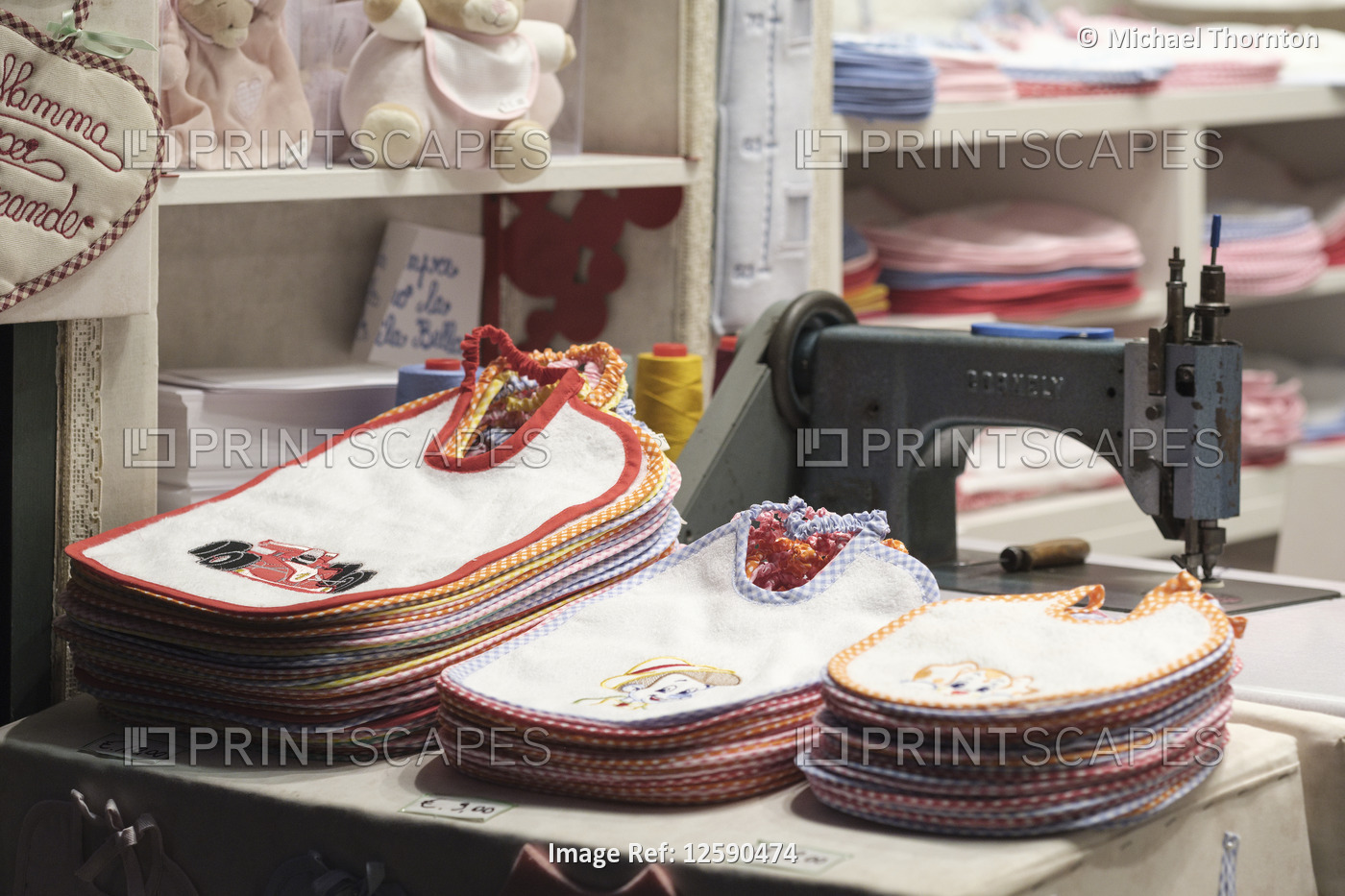 Babies bibs personally inscribed while you wait, old city shop in Lucca; ...