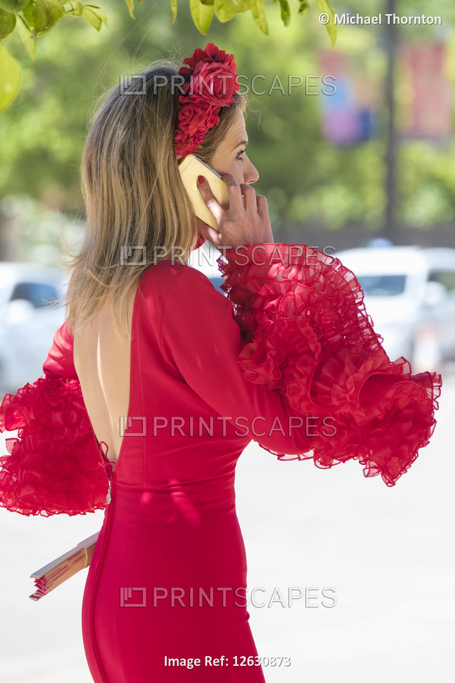 Lady in Red Flamenco dress on Mobile phone, Jerez de la Frontera, Feria de ...