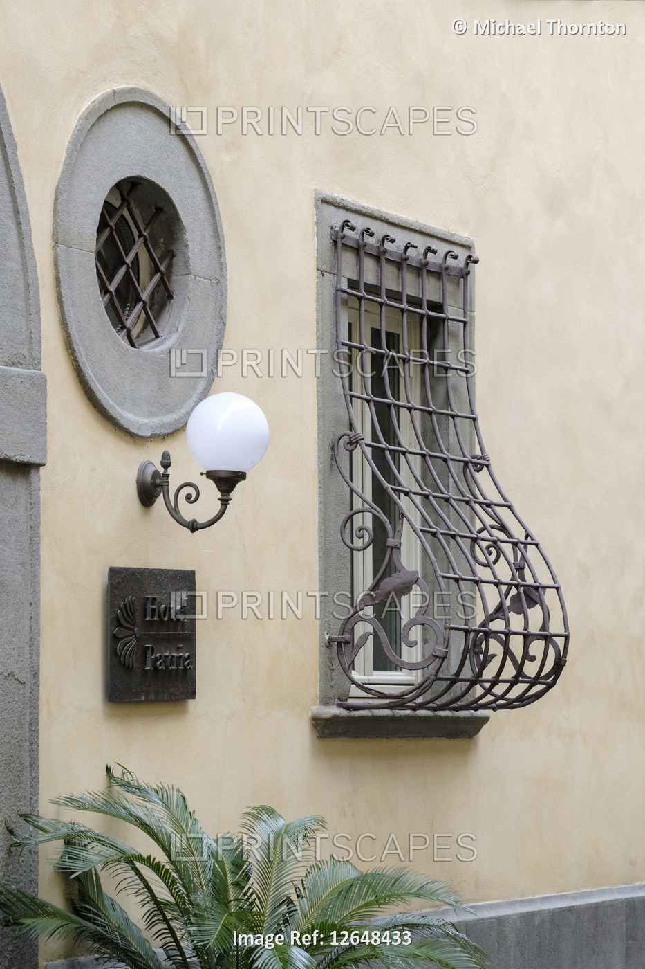 Unusual decorative wrought iron window security grill on house in old town of ...