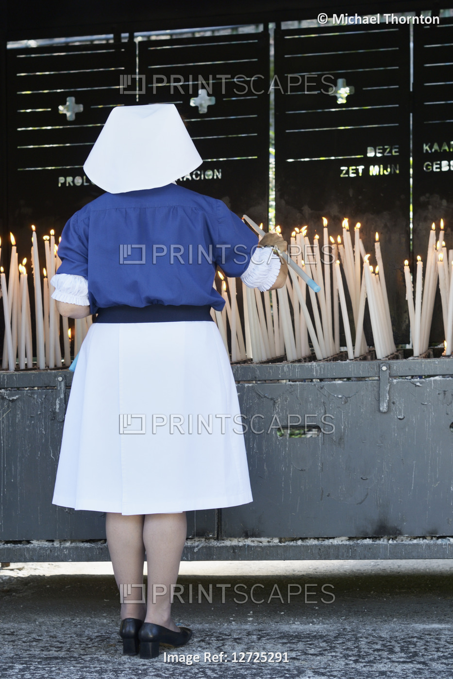 Nun lighting a blessed candle, Sanctuary of our lady of Lourdes, ...