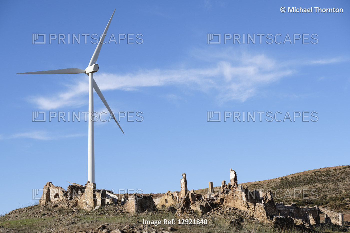 Wind Turbine towering over old farmhouse ruin, Almargen, Malaga, Andalucia, ...