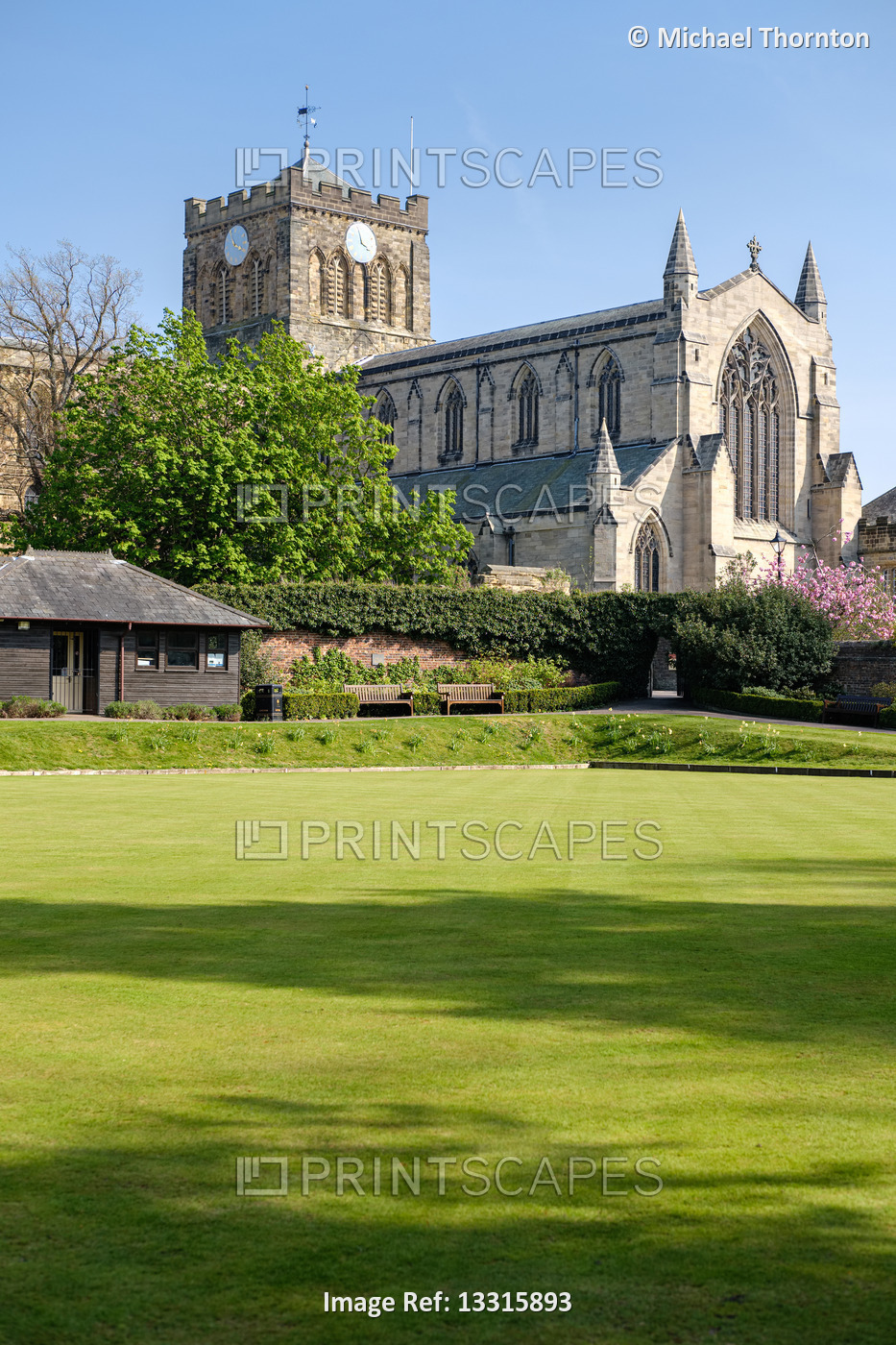 Hexham Abbey, Northumberland with empty Bowling green in foreground
