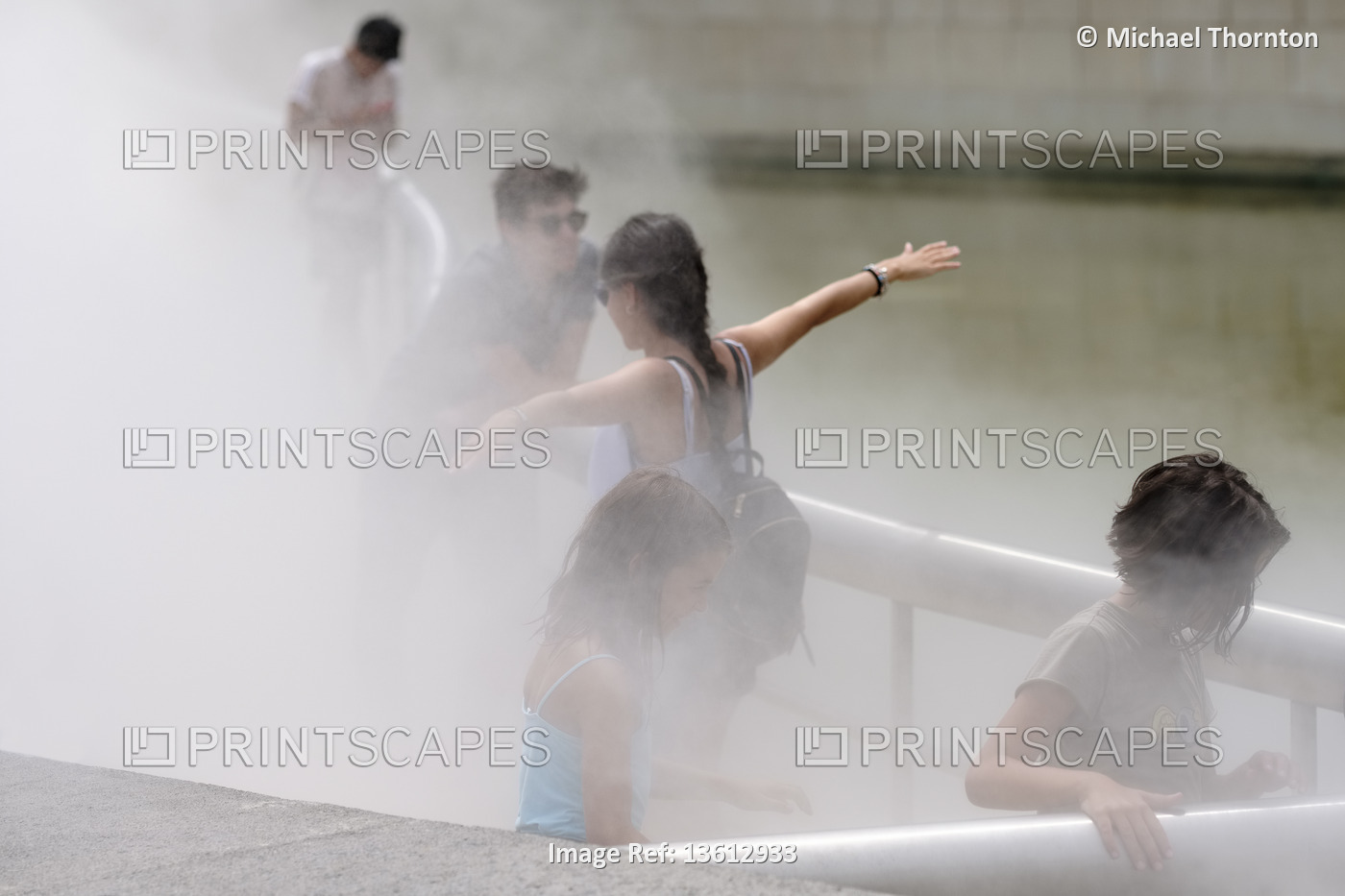Young people enjoying the regular water vapour released outside the Guggenheim ...