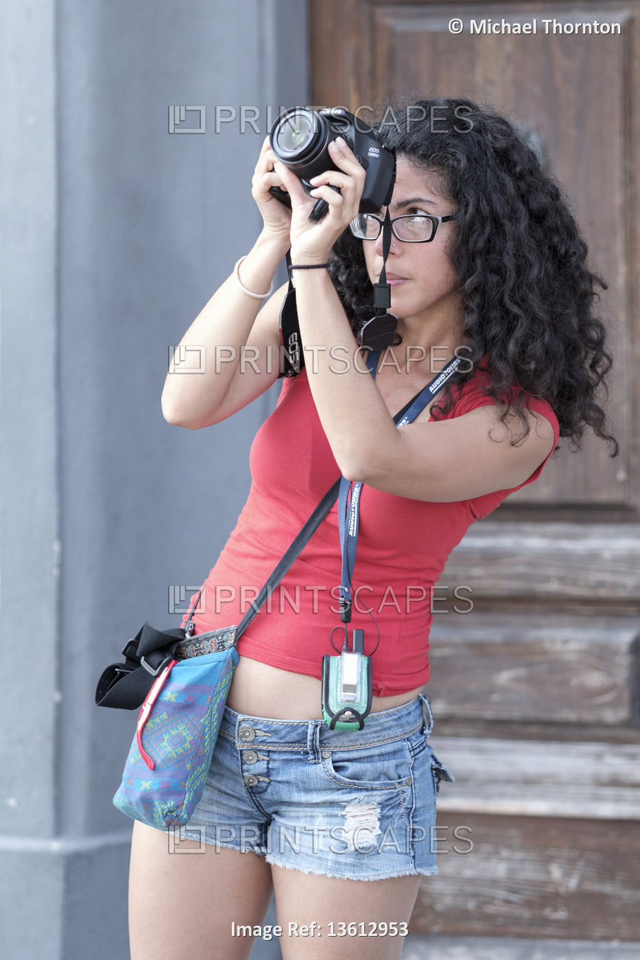 Young lady tourist taking holiday photographs, Pisa, Tuscany, Italy, Europe.