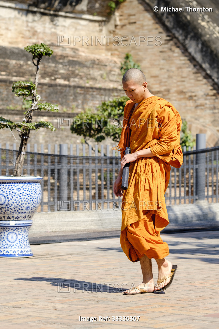 Monk walking at Wat Phra That Chedi Luang, Thailand,
