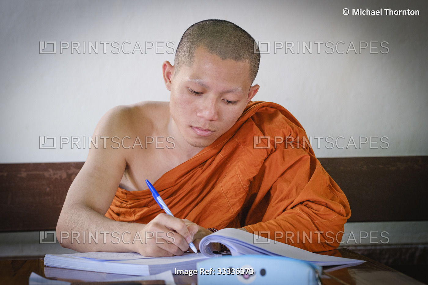 Novice monk studying at Wat Phra That Chedi Luang, Thailand,