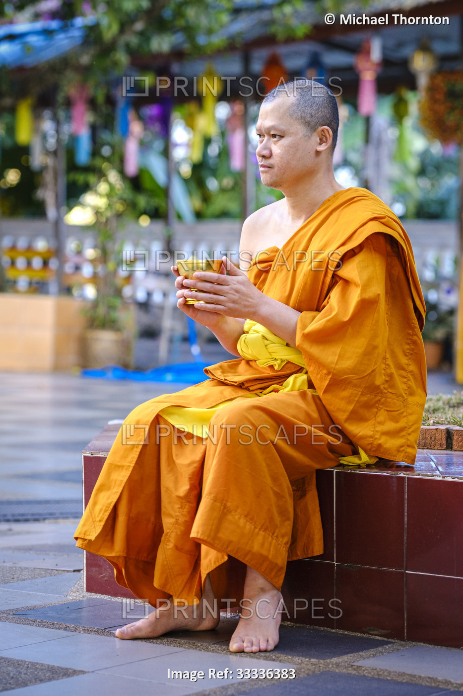 Monk sitting at the Wat Phra That Doi Suthep, Chiang Mai, Thailand.